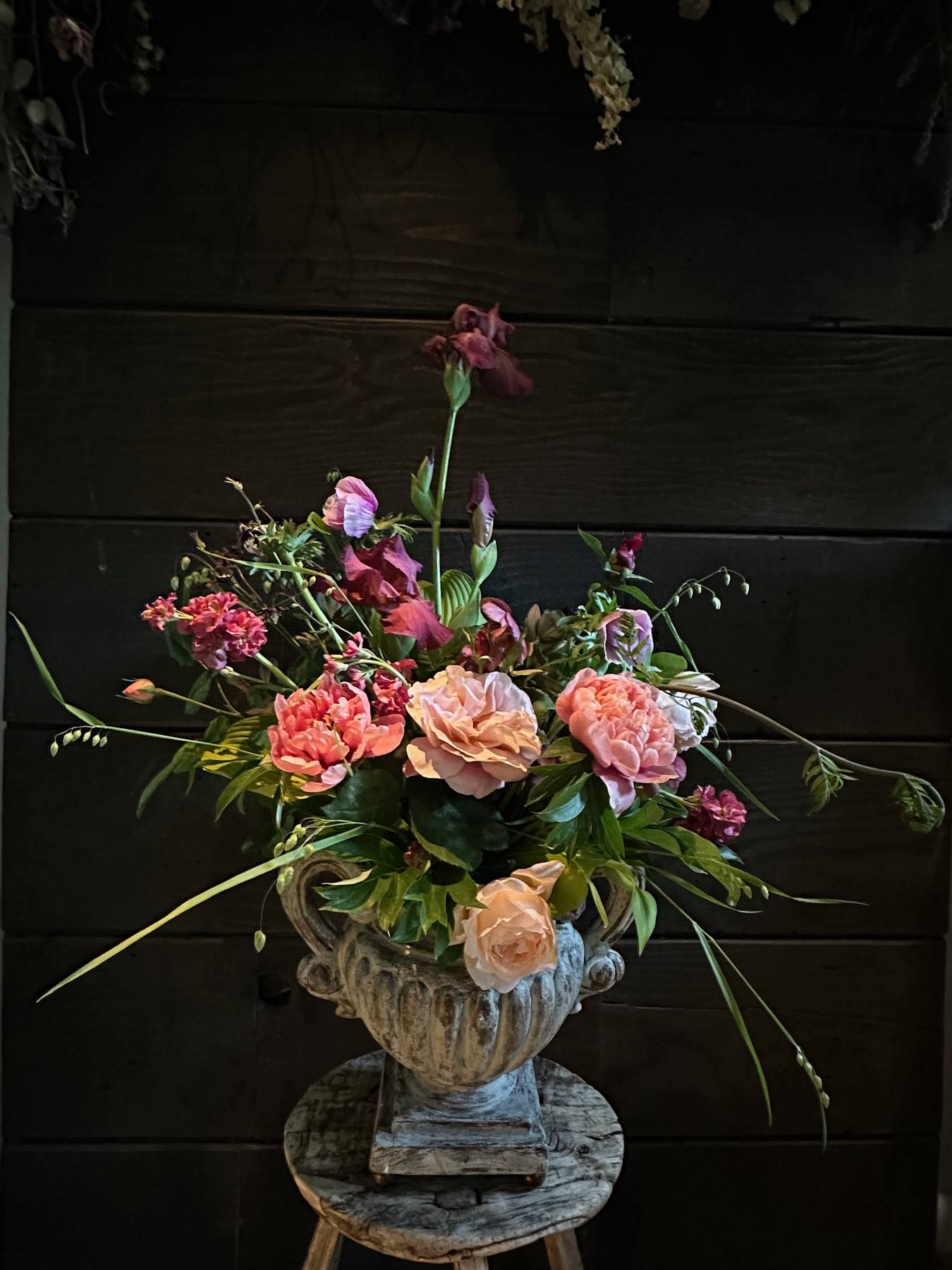 Garden-inspired pink arrangement in an urn