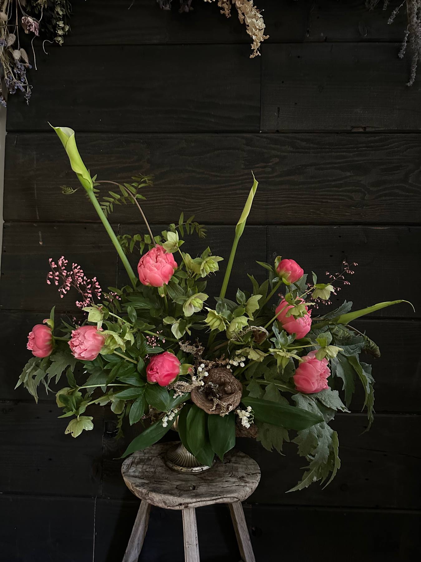 Pink flowers and calla lilies in a vase