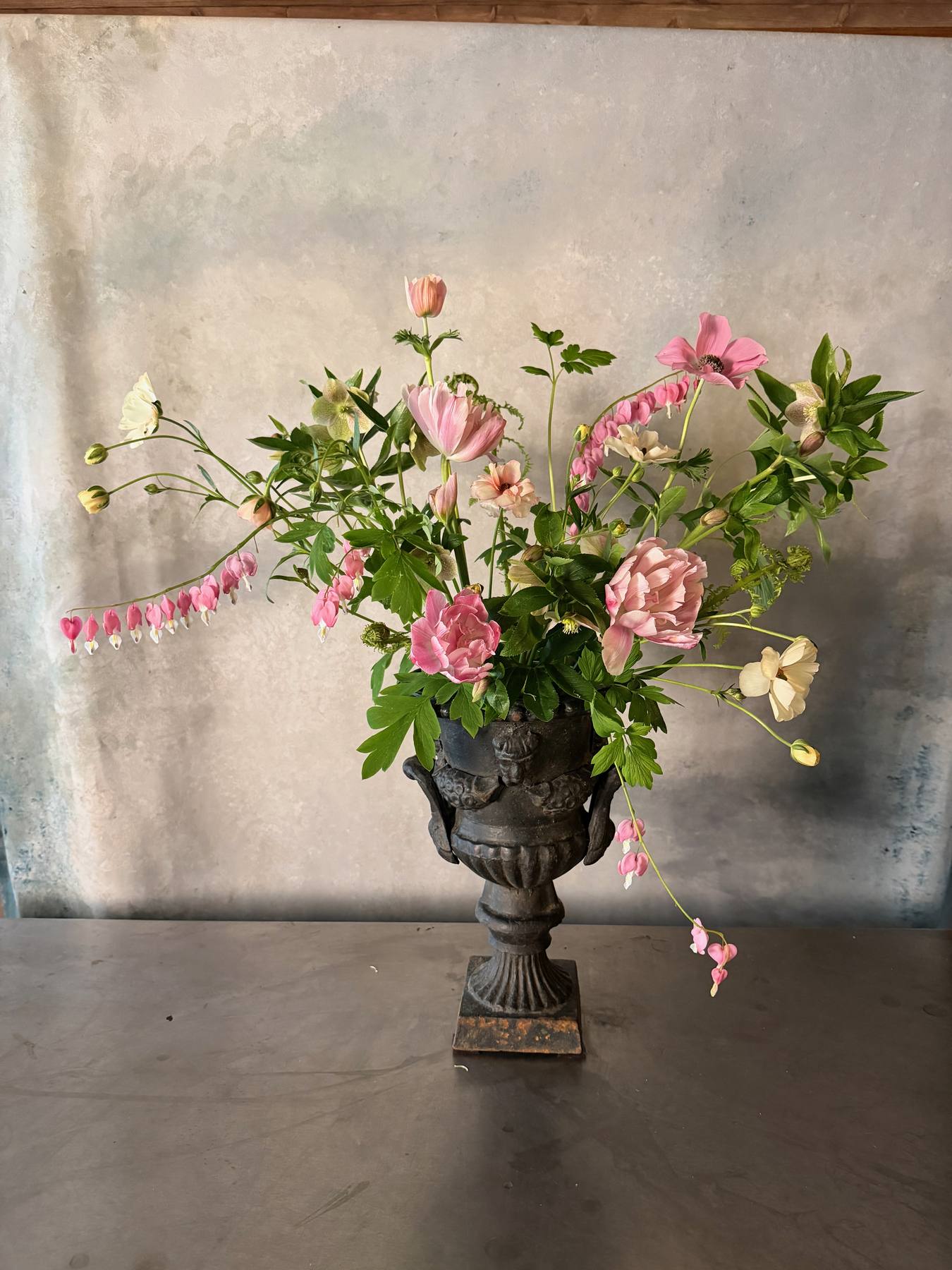 Pink arrangement in a decorative urn