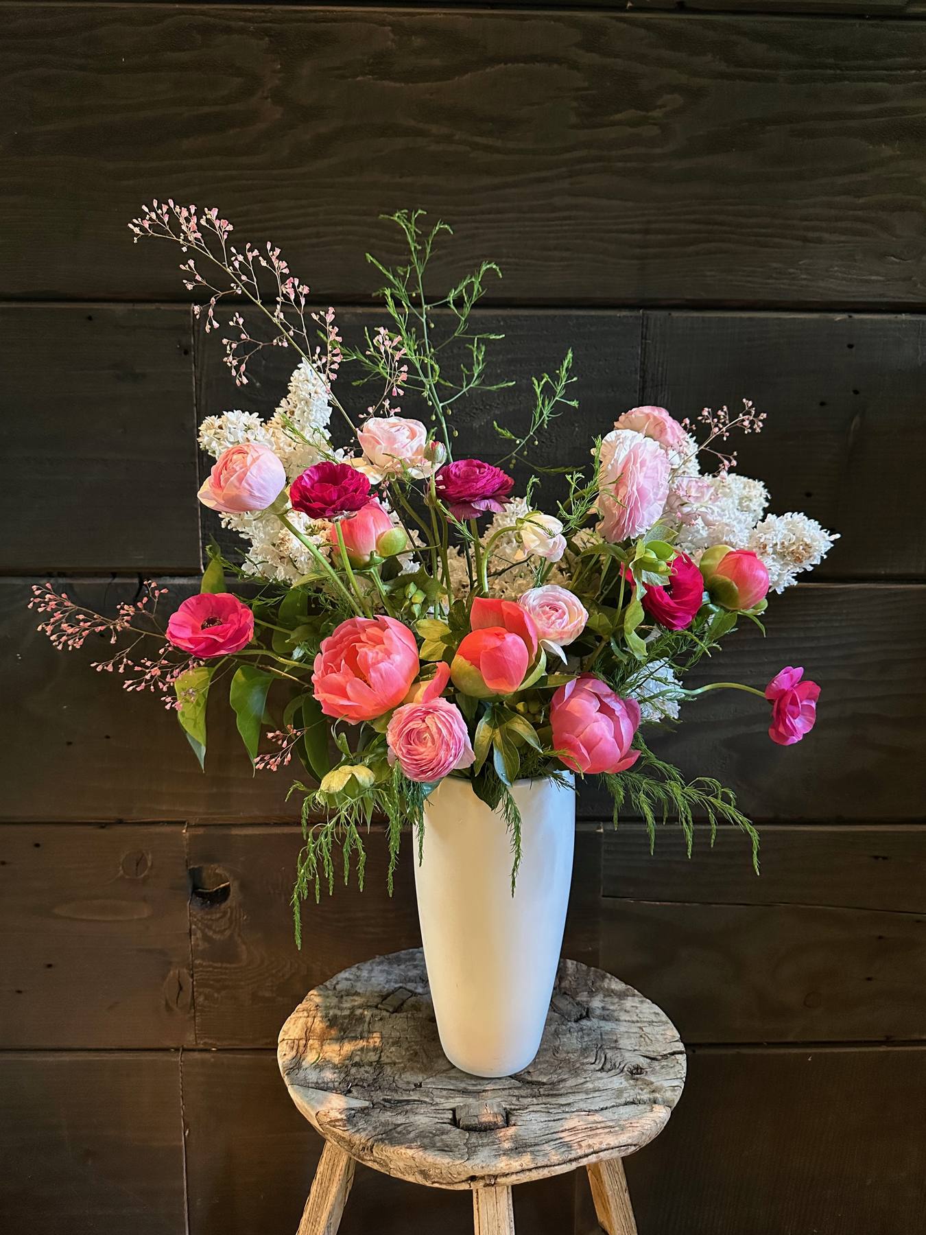 Pink floral arrangement in a white vase