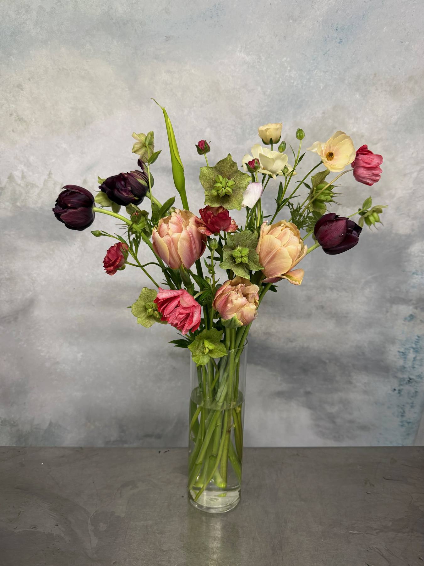 Spring flower arrangement in a clear vase