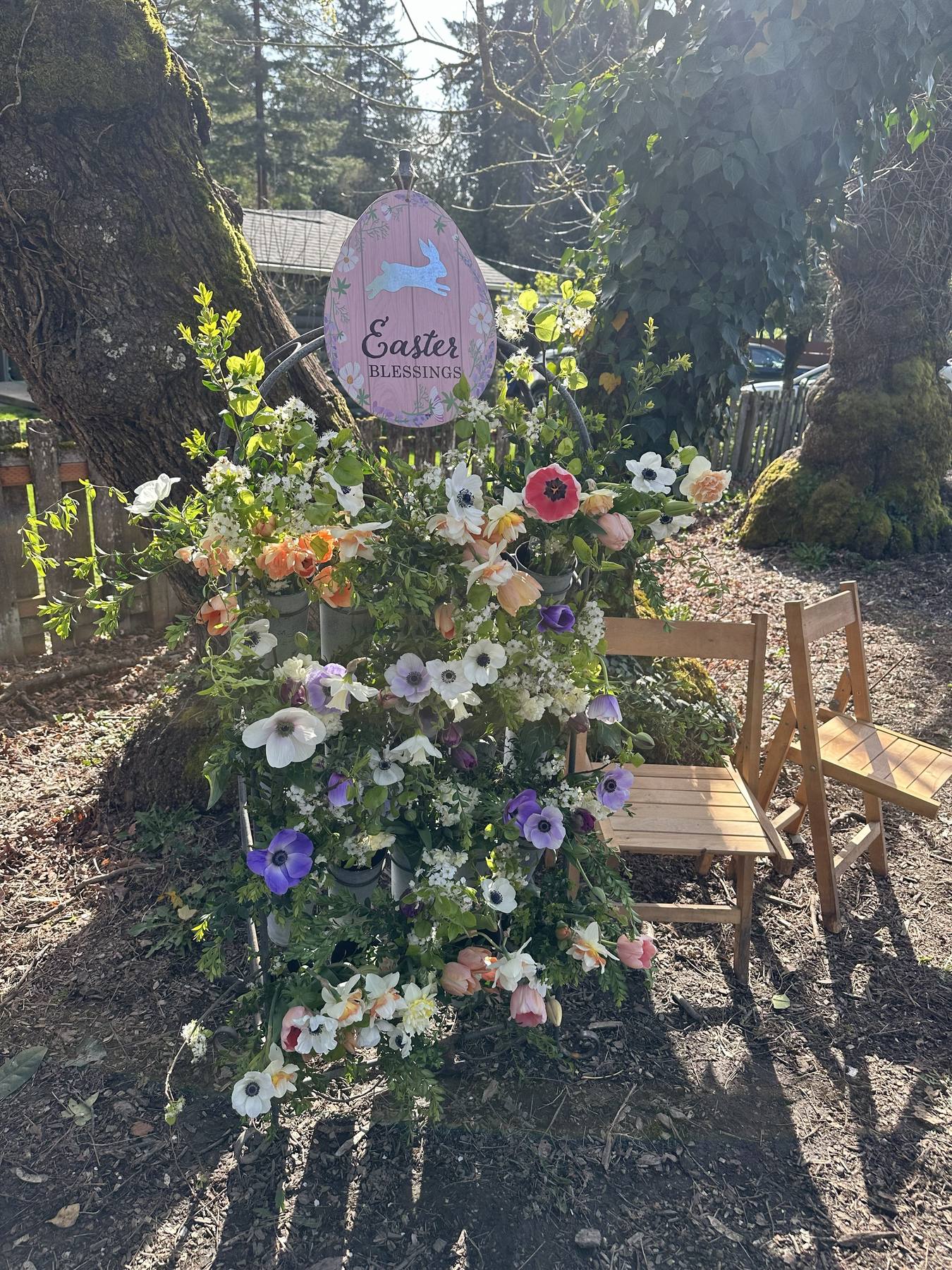 Seasonal spring bouquet bar display with flowers and an Easter sign