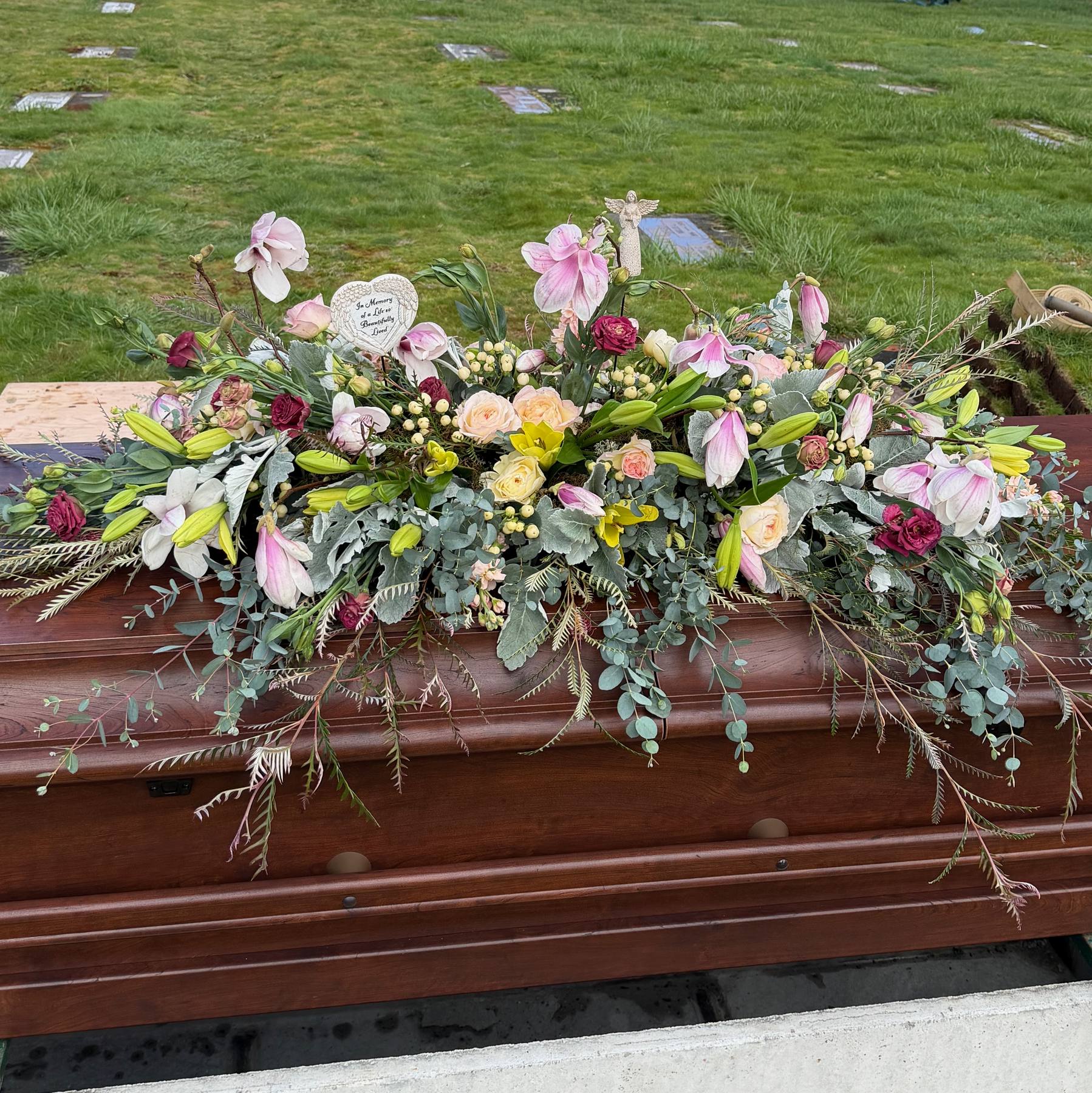 Full pastel casket flower arrangement