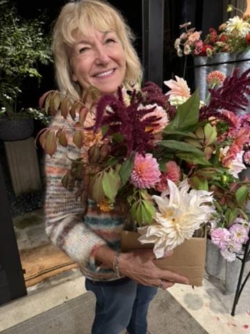 Happy workshop guest with bouquet